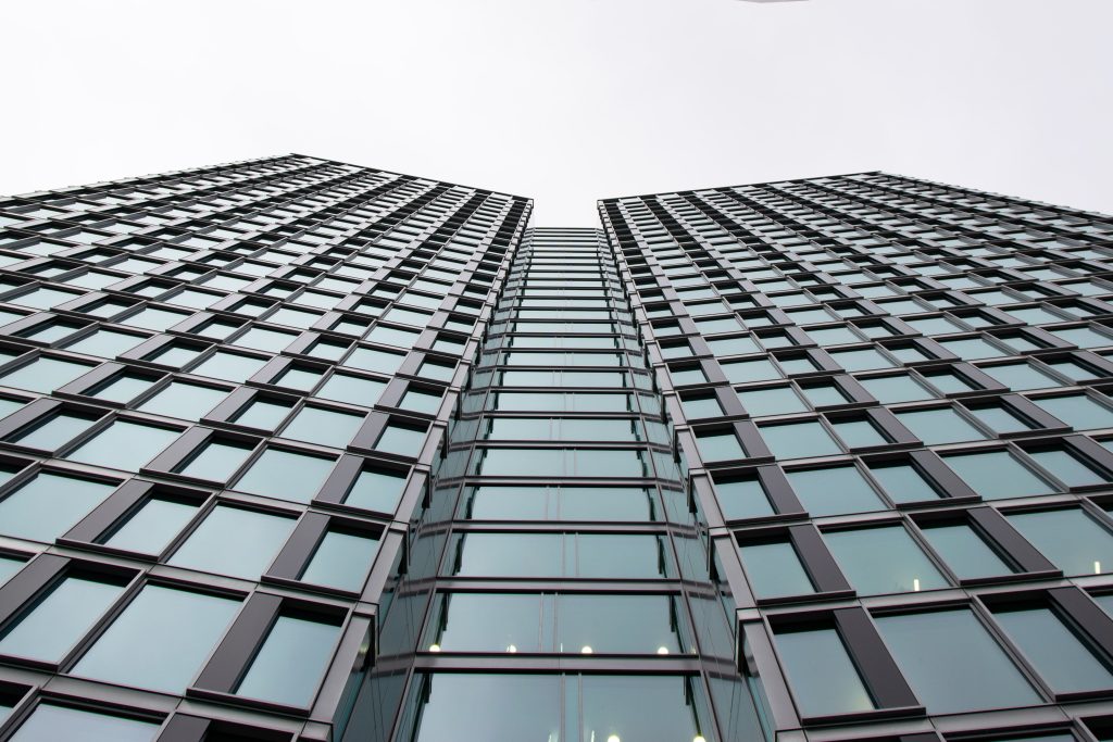 Low angle view of a modern office building with glass facade in Warsaw, Poland.